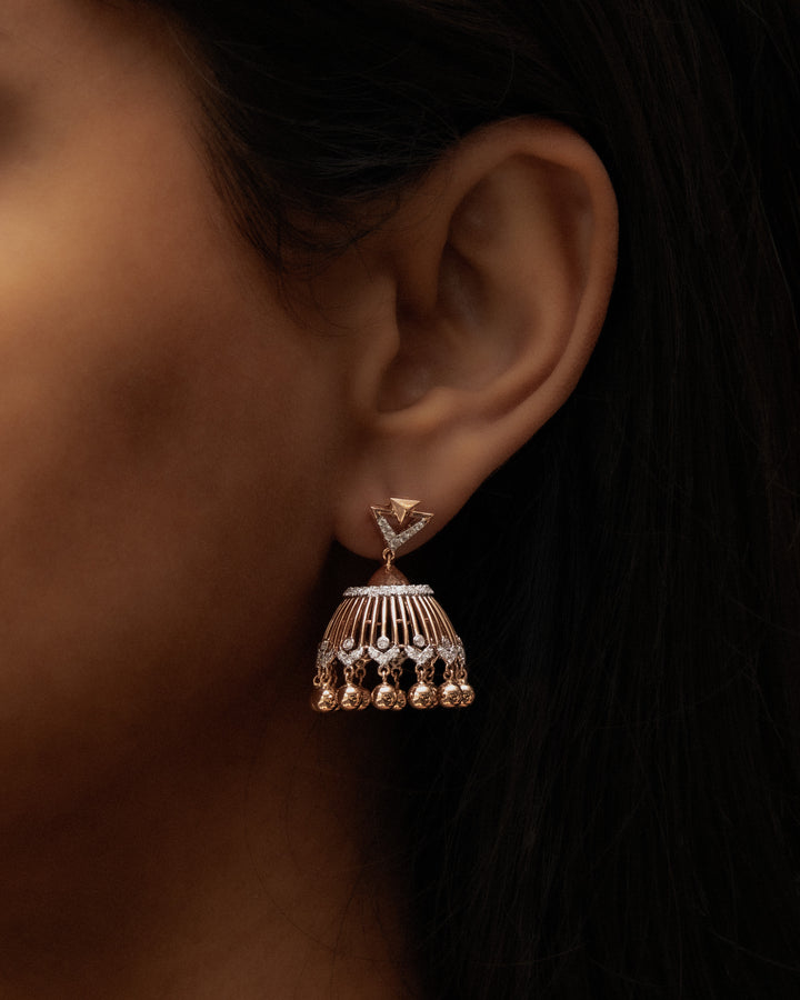 Close-up of a person wearing a decorative earring with intricate design.